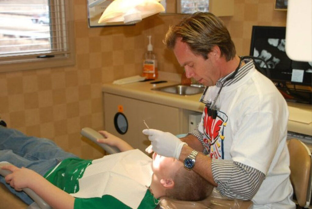 Doctor examining child patient within Remmers Dental