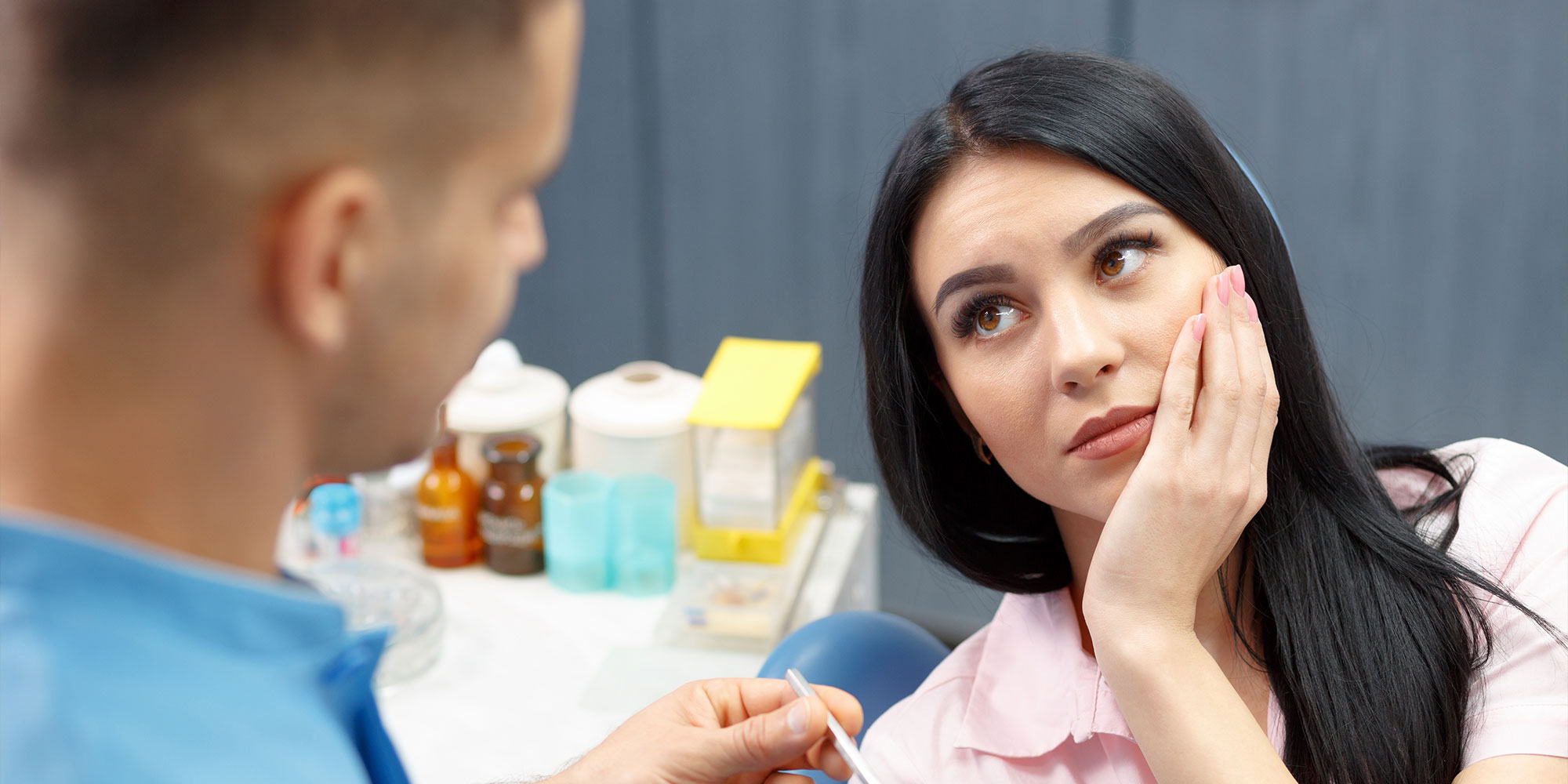 dental patient with mouth pain seeking dental treatment within the dental center