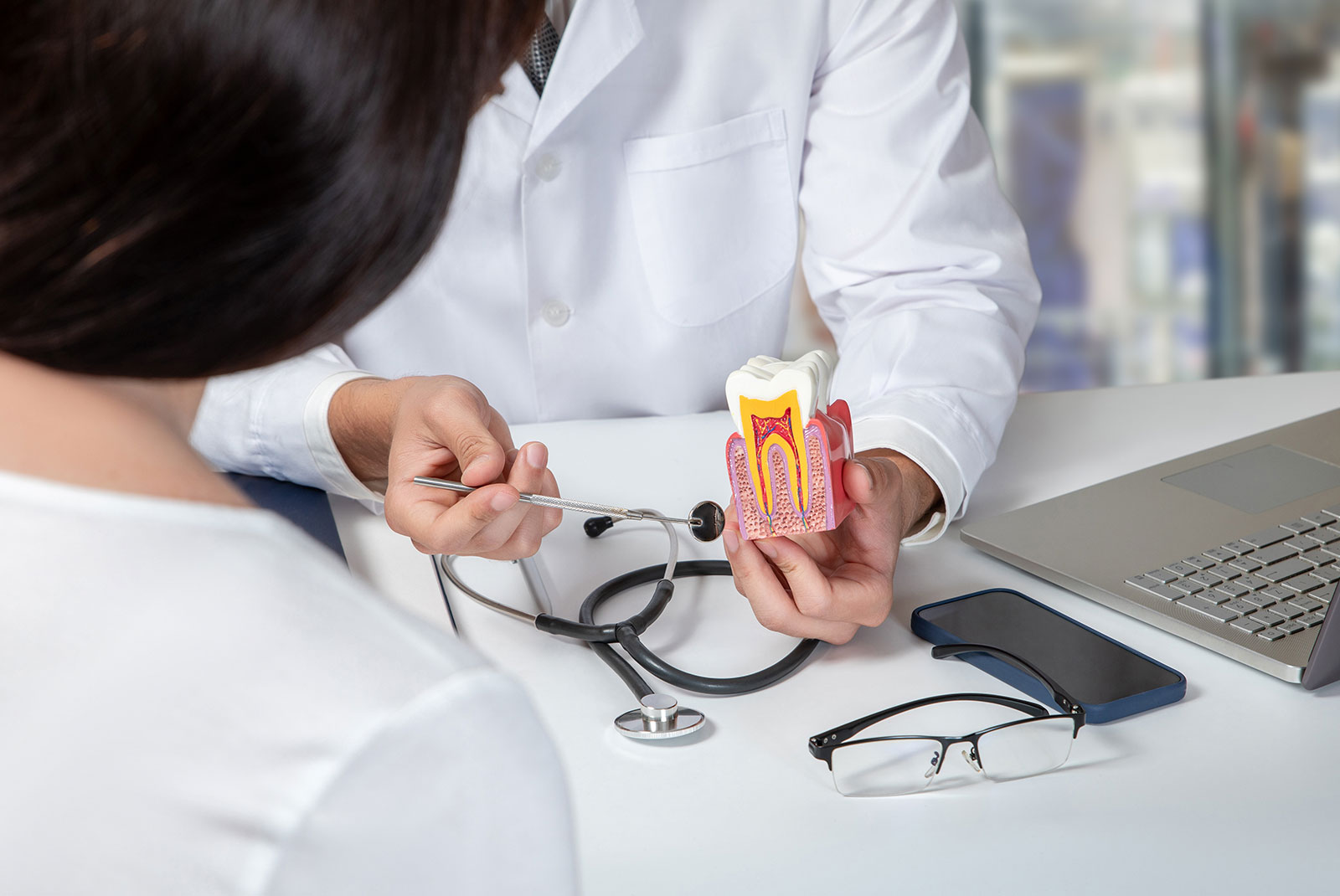 Doctor consulting a female patient about dental diseases